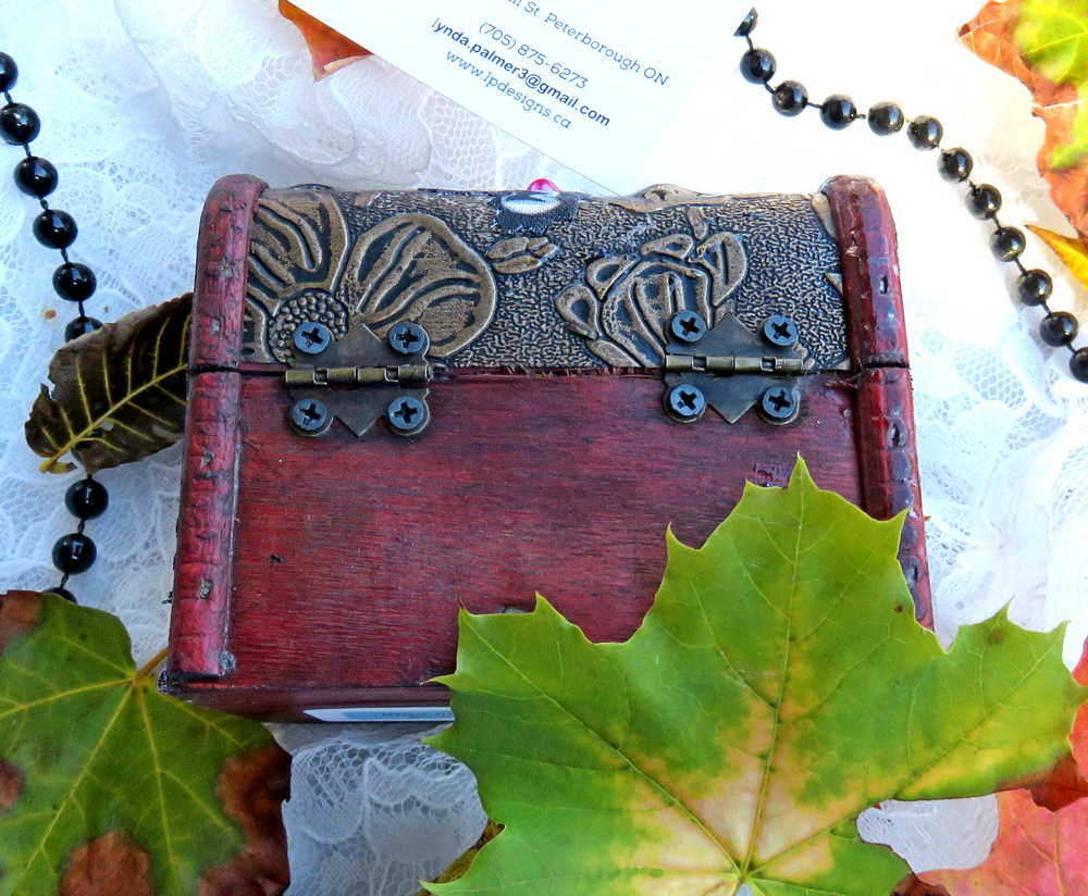 Business Card Holder like no other.  Fabric Skull with Wings Wearing a Burgundy Head Scarf
