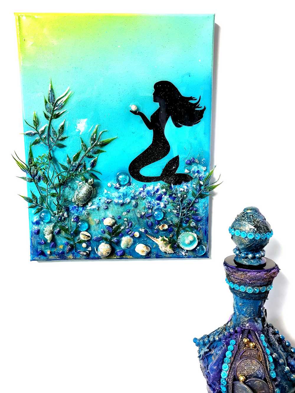 3D Resin Canvas Art of a Beautiful Silhouette of a Mermaid, a Glass Sea Turtle, Seashells, Greenery and Stones