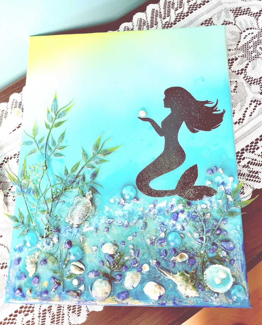 3D Resin Canvas Art of a Beautiful Silhouette of a Mermaid, a Glass Sea Turtle, Seashells, Greenery and Stones