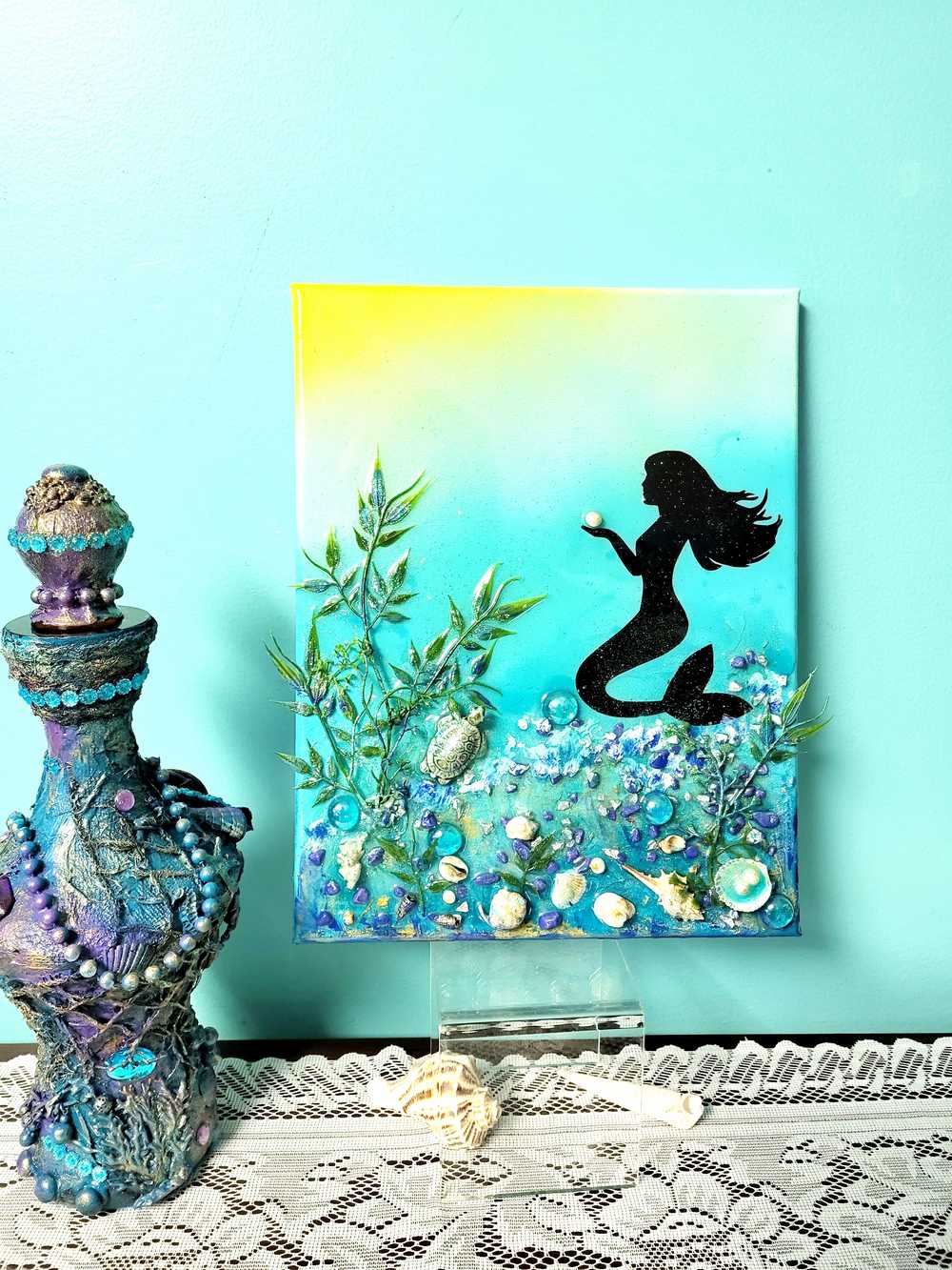 3D Resin Canvas Art of a Beautiful Silhouette of a Mermaid, a Glass Sea Turtle, Seashells, Greenery and Stones
