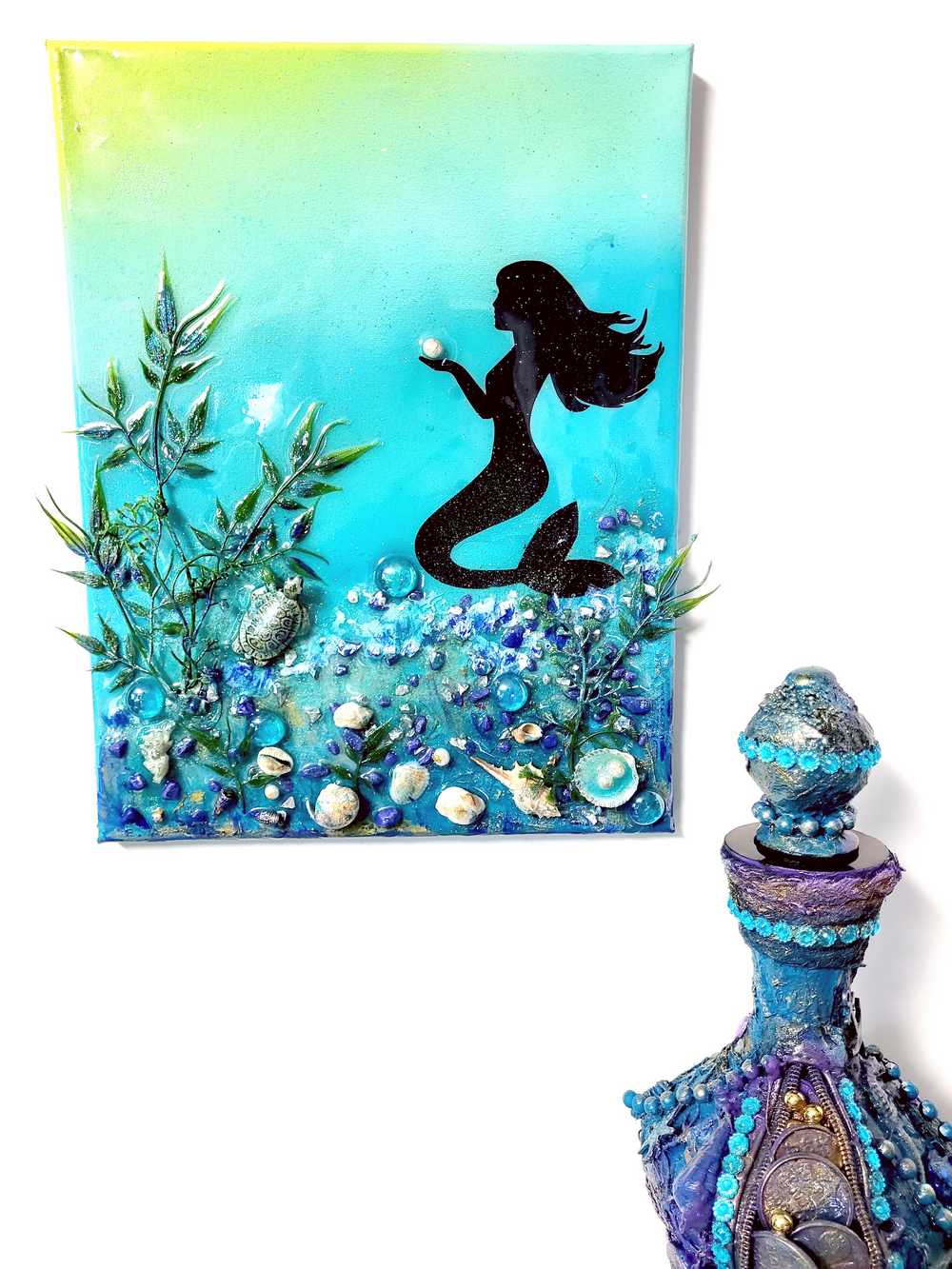 3D Resin Canvas Art of a Beautiful Silhouette of a Mermaid, a Glass Sea Turtle, Seashells, Greenery and Stones