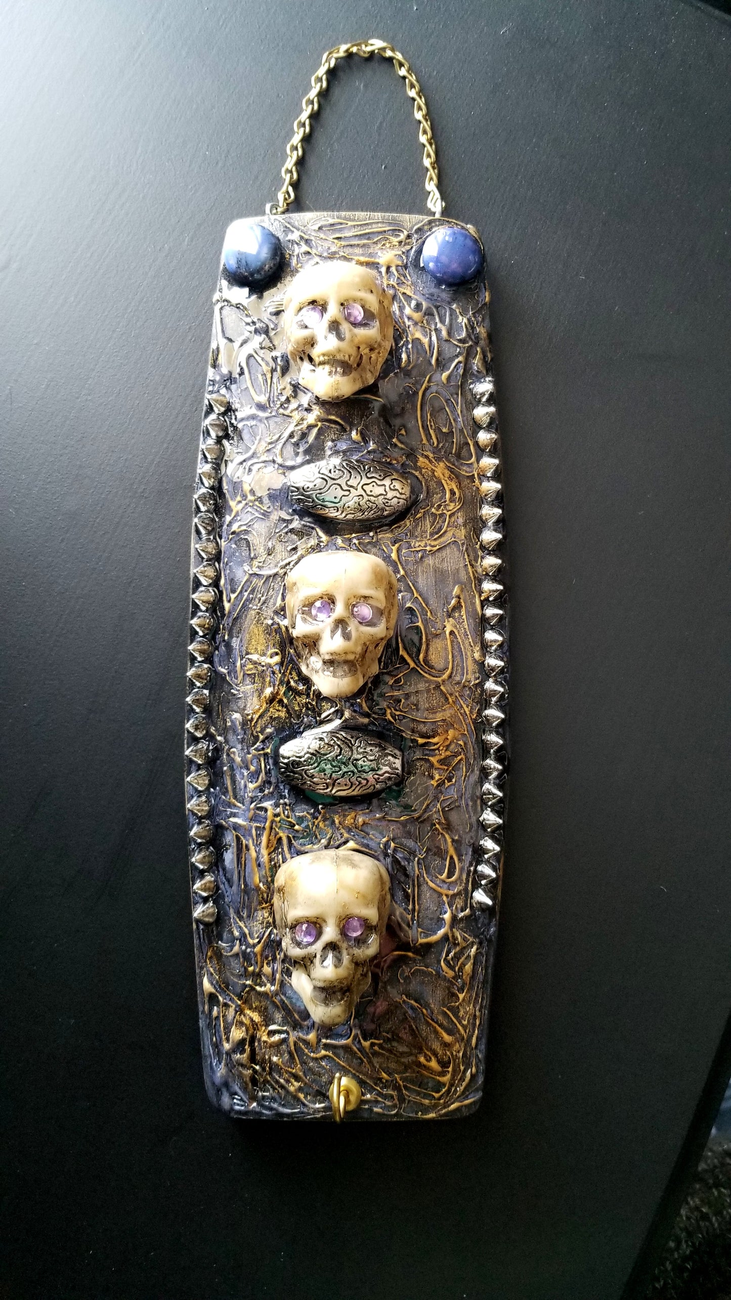 3 Skulls on a Spiked Plaque