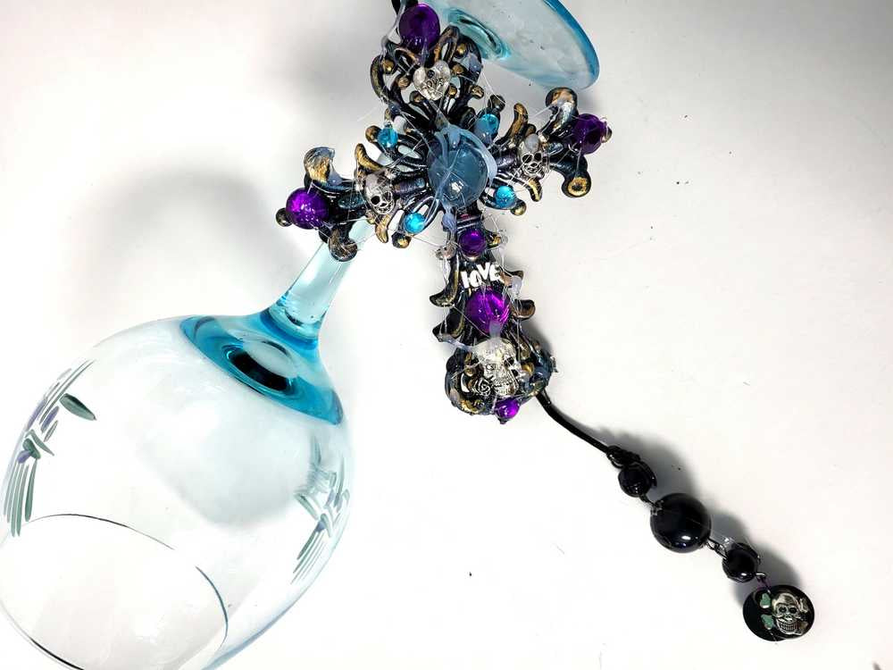 Plastic Cross and Skull Ornament with Teal and Purple Rhinestones
