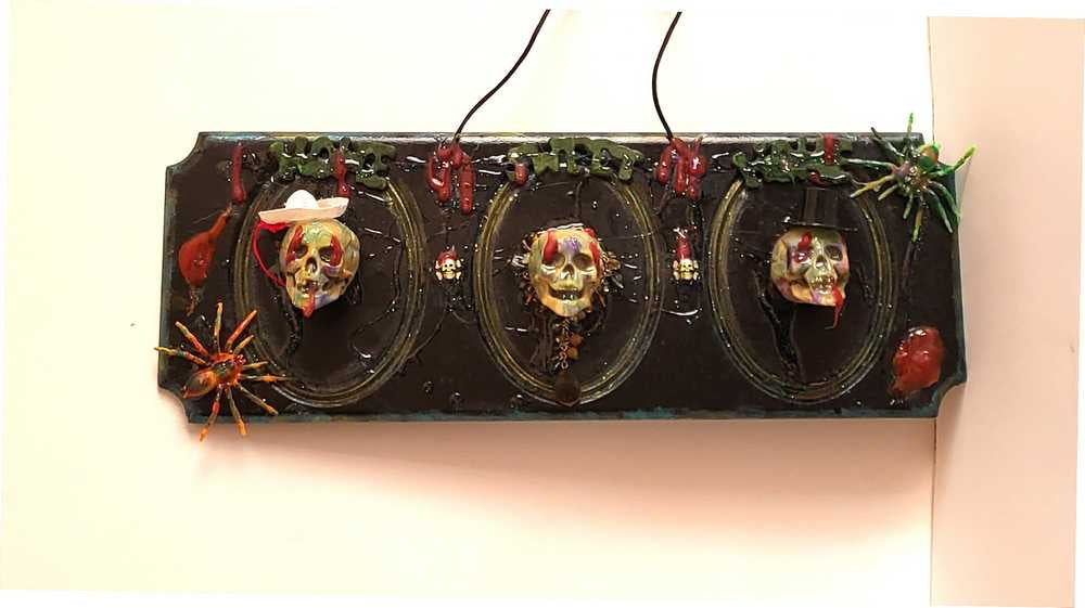3D Family Portraits of a Handsome Skull Family on a Wall Plaque