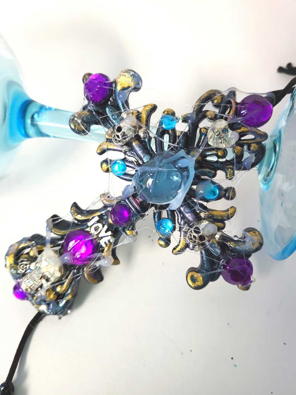 Plastic Cross and Skull Ornament with Teal and Purple Rhinestones