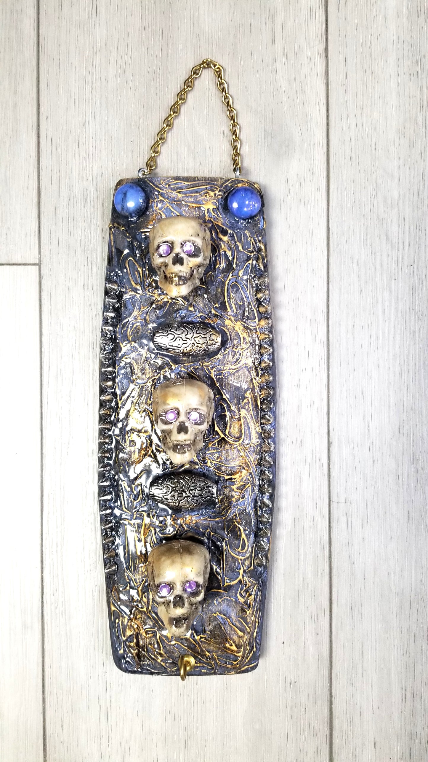 3 Skulls on a Spiked Plaque