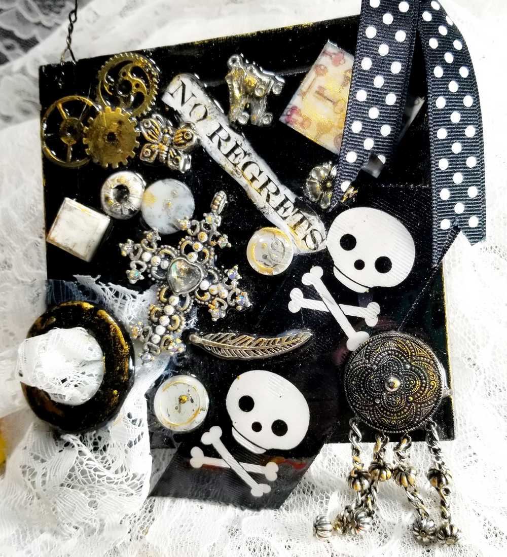 Skull & Bones Wall Plaque in Black & Gold, with Curly Wire Ribbon "No Regrets"