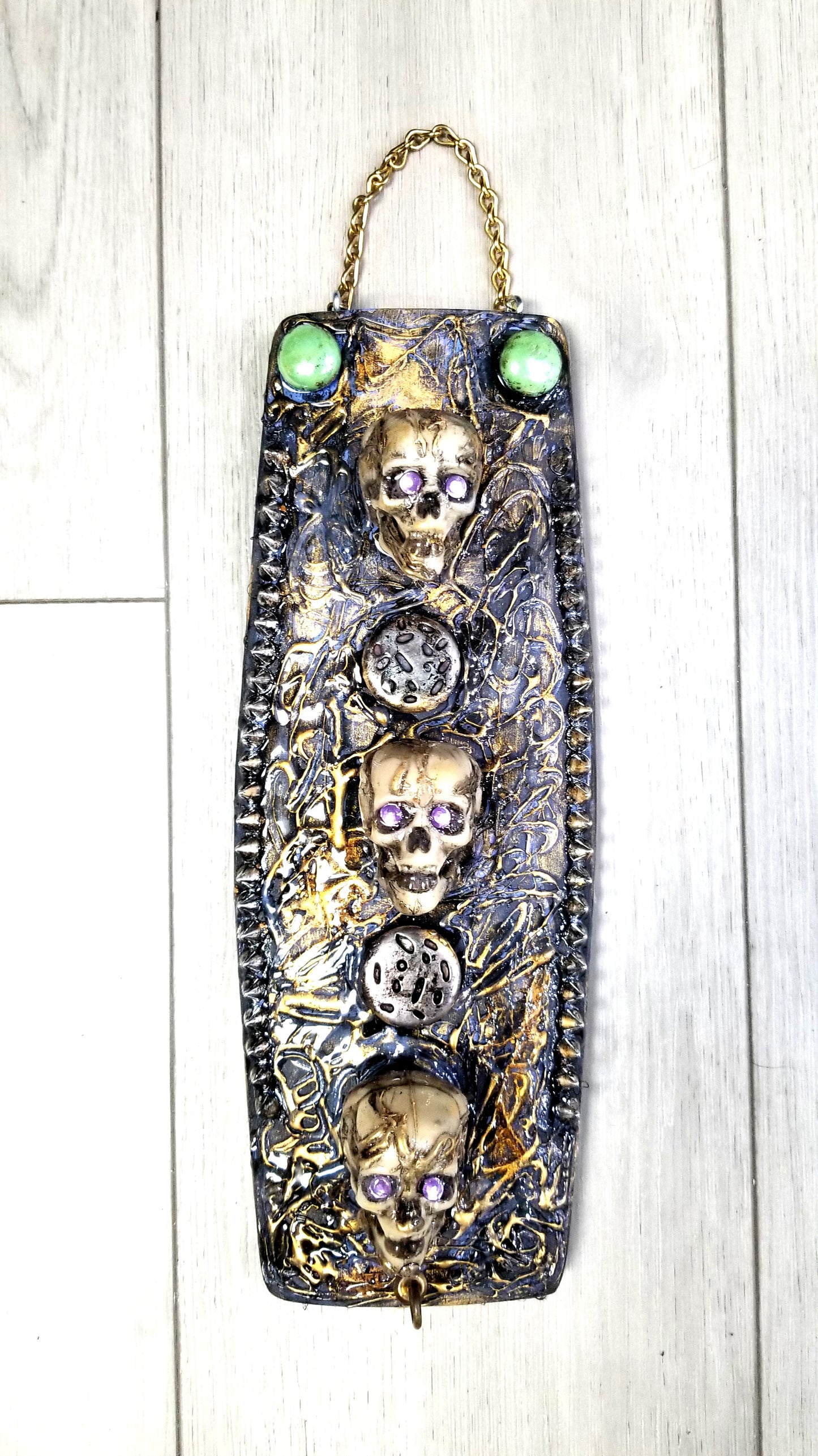 3 Skulls on a Spiked Plaque