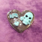 Black Porcelain Heart Shaped Brooch with a Teal Skull, Love and a Heart Charm