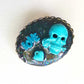 Porcelain Black Oval Shaped Brooch with Hand Painted Teal Skull, Heart & Love Charms