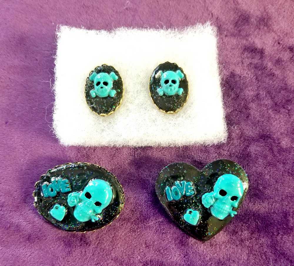 Black Porcelain Heart Shaped Brooch with a Teal Skull, Love and a Heart Charm