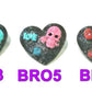 Black Porcelain Heart Shaped Brooch with a Pink Skull and a Teal Heart & Love Charm