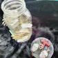 1 litre Mason Jar Filled with Hard Candy. With a Wooden Lid with Resin Skulls & a Cross