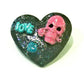 Black Porcelain Heart Shaped Brooch with a Pink Skull and a Teal Heart & Love Charm