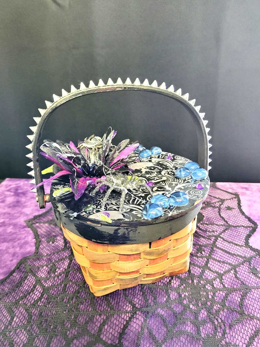 Wood Basket Covered with Black Skull Fabric, with a Purple & Black Flower, Blue Glass Cabochons & a Large Sparkley Spider