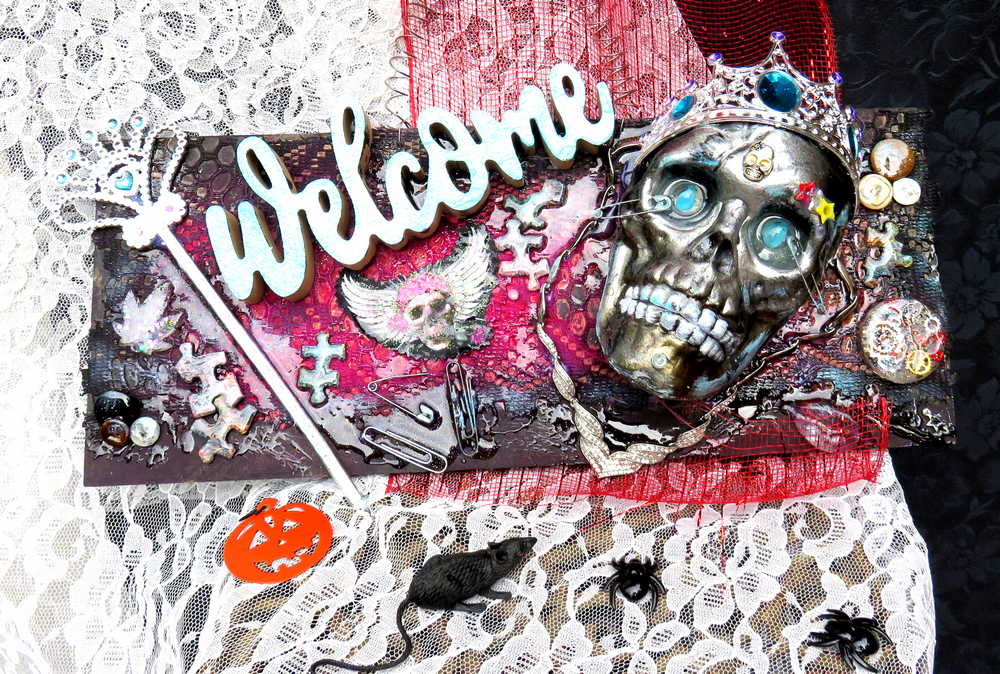 Welcome Sign With a Silver Colored Skull With  Piercings Wearing a Crown And Her Scepter