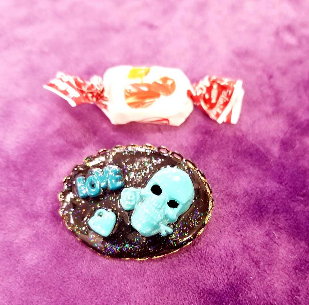 Porcelain Black Oval Shaped Brooch with Hand Painted Teal Skull, Heart & Love Charms