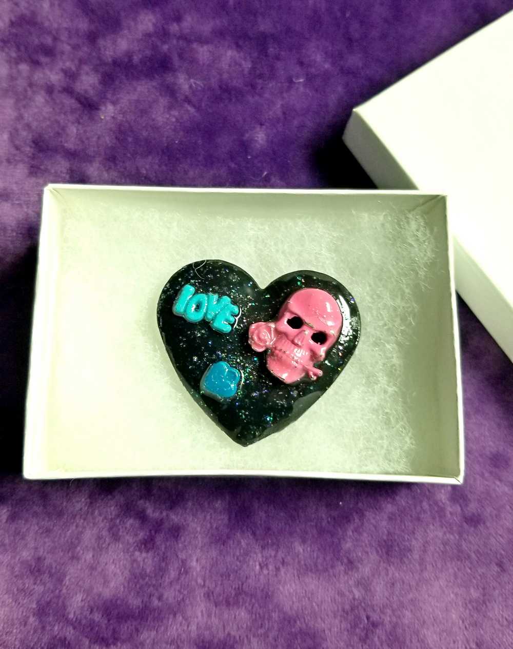 Black Porcelain Heart Shaped Brooch with a Pink Skull and a Teal Heart & Love Charm