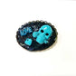 Porcelain Black Oval Shaped Brooch with Hand Painted Teal Skull, Heart & Love Charms