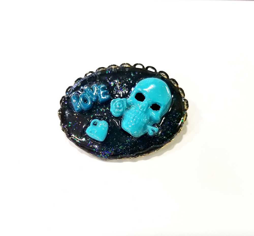 Porcelain Black Oval Shaped Brooch with Hand Painted Teal Skull, Heart & Love Charms