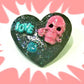 Black Porcelain Heart Shaped Brooch with a Pink Skull and a Teal Heart & Love Charm