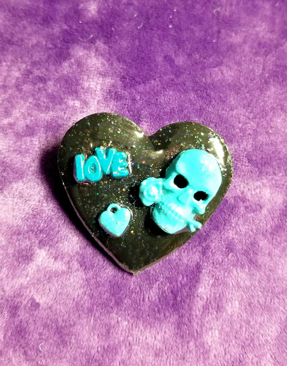 Black Porcelain Heart Shaped Brooch with a Teal Skull, Love and a Heart Charm