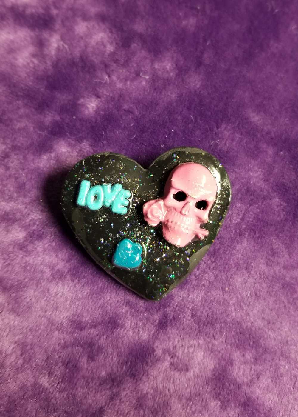 Black Porcelain Heart Shaped Brooch with a Pink Skull and a Teal Heart & Love Charm