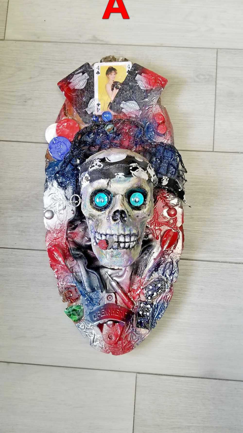 Skull Head Bottle Opener on Oval Slab of Wood, Surrounded by Darts, Dice, Poker Chips, Girlie Playing Cards, Smoking a BIg One