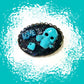 Porcelain Black Oval Shaped Brooch with Hand Painted Teal Skull, Heart & Love Charms