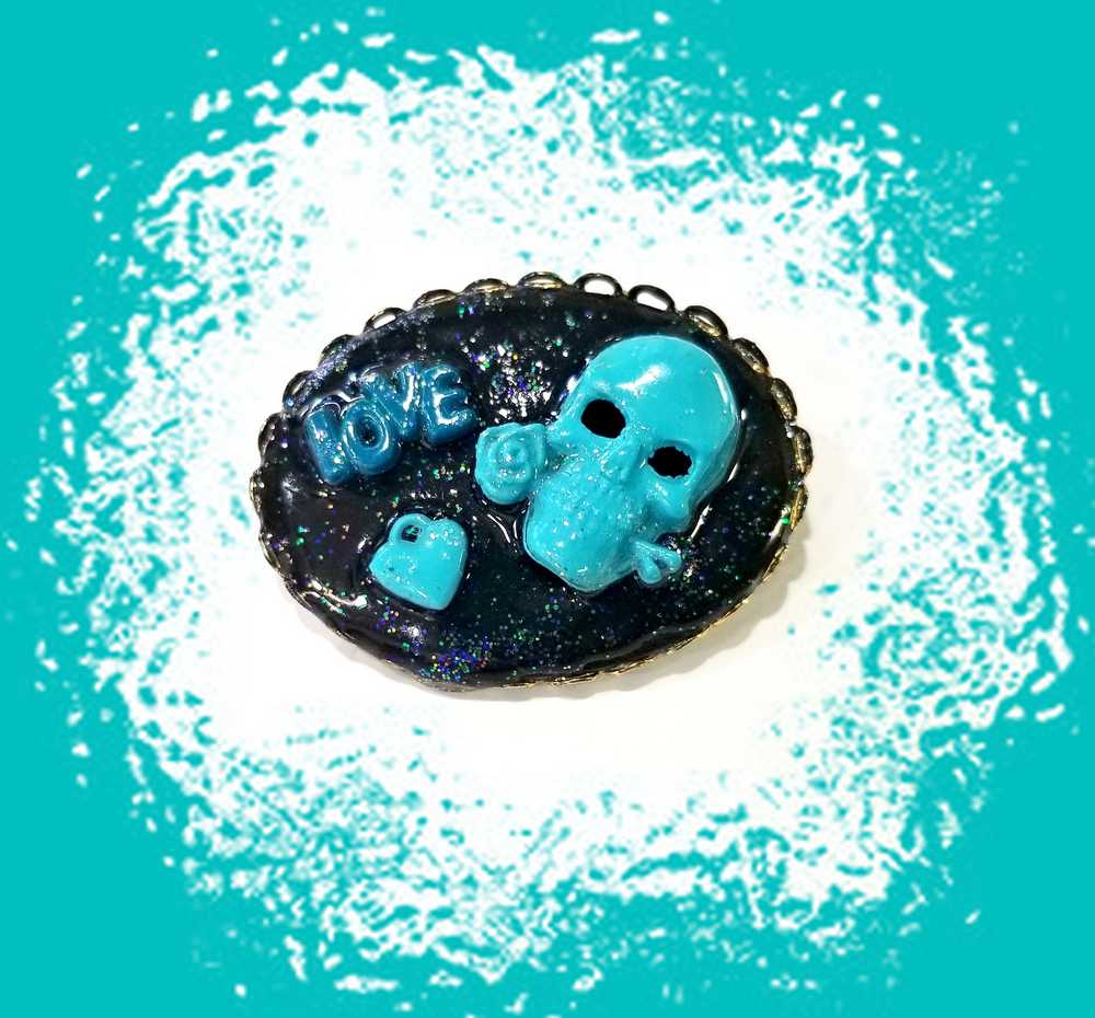 Porcelain Black Oval Shaped Brooch with Hand Painted Teal Skull, Heart & Love Charms