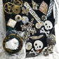 Skull & Bones Wall Plaque in Black & Gold, with Curly Wire Ribbon "No Regrets"