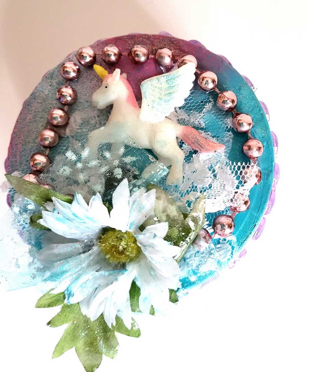 Recycled Round Jewelry Box with a Flying Pink Unicorn and a Daisy