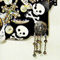 Skull & Bones Wall Plaque in Black & Gold, with Curly Wire Ribbon "No Regrets"