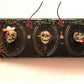 3D Family Portraits of a Handsome Skull Family on a Wall Plaque