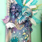 Large Teal Wood Clock with Skull and all Her Jewels, with Lights