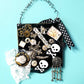 Skull & Bones Wall Plaque in Black & Gold, with Curly Wire Ribbon "No Regrets"