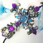 Plastic Cross and Skull Ornament with Teal and Purple Rhinestones